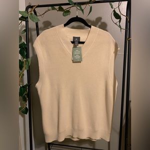 This is an H and M sweater vest in the color creamy beige. SIZE L
